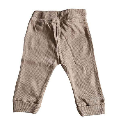 Studio Spruitje tweedehands babybroekje beige ribstof met bruin striklint en omslagboorden.