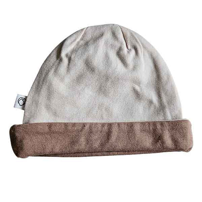 Studio Spruitje tweedehands babymutsje poederroze met beige omslagrand van zachte jersey stof.