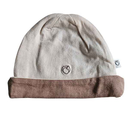 Studio Spruitje tweedehands babymutsje poederroze met beige omslagrand van zachte jersey stof.